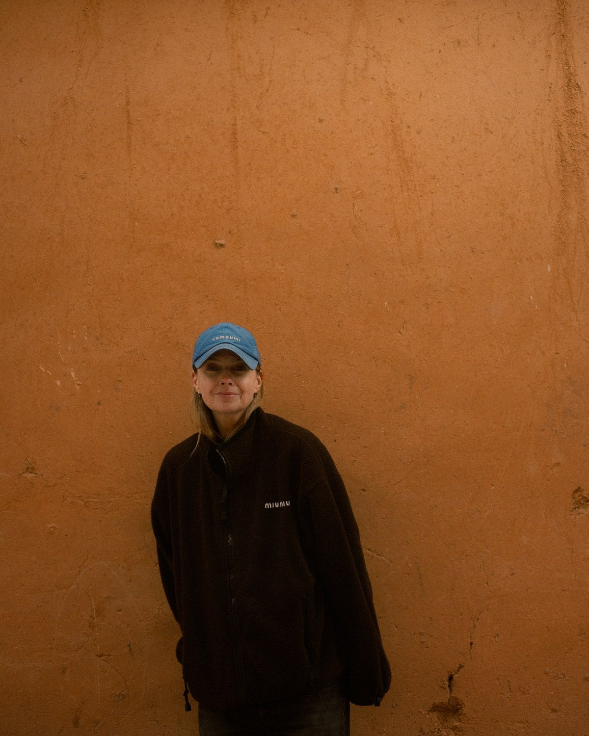Lyn Harris against an ochre wall